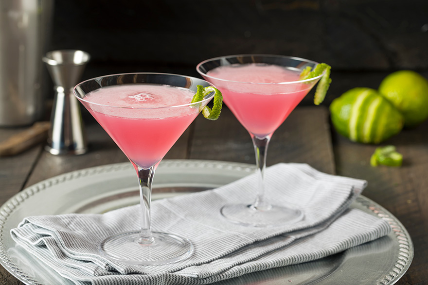 Two pink cocktails garnished with lime